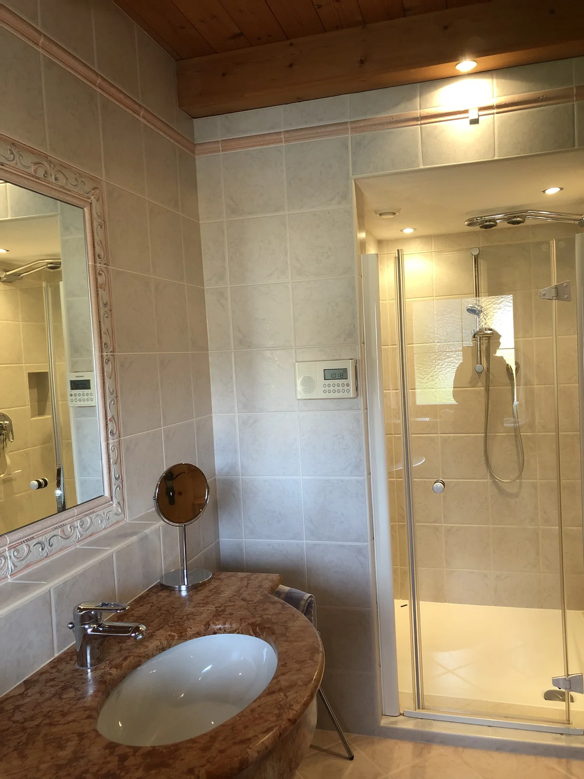 Badezimmer mit Waschtisch, Spiegel und Dusche